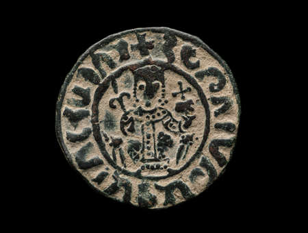 Ancient copper armenian coin with ruler portrait isolated on black, close-up shot