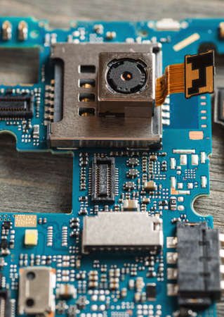 Disassembled parts of cell phone close-up shot, selective focus, repair and service concept, verticalの写真素材