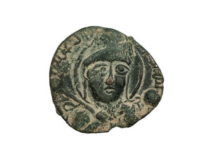Ancient copper islamic coin with portrait isolated on white, close-up shotの写真素材