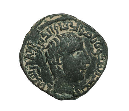 Ancient bronze islamic coin with portrait isolated on white, close-up shotの写真素材