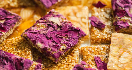 Oriental sweets square shape with rose petals and nuts, selective focus, macro shotの写真素材