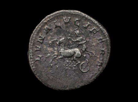 Ancient silver coin with chariot isolated on black, macro shotの写真素材