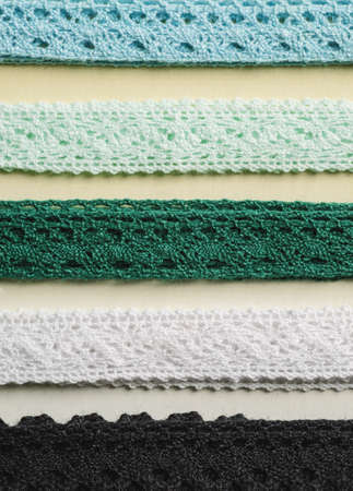 Different color fabric ribbons rows close-up shot, selective focus