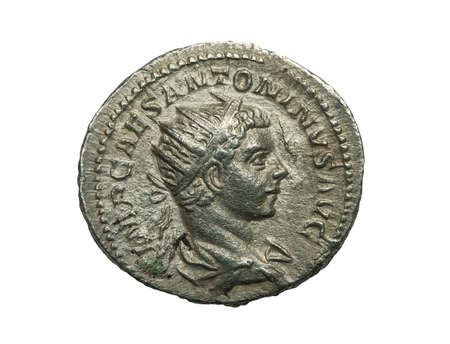 Ancient silver roman coin isolated on white, close-up shotの写真素材