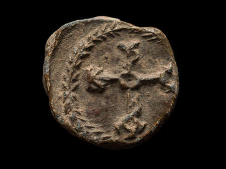 Ancient post seal with monogram on it isolated on black, close-up shotの写真素材