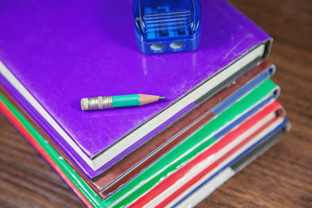 Pencil sharpener with small pencil on stack of books, close-up shot, selective focusの写真素材
