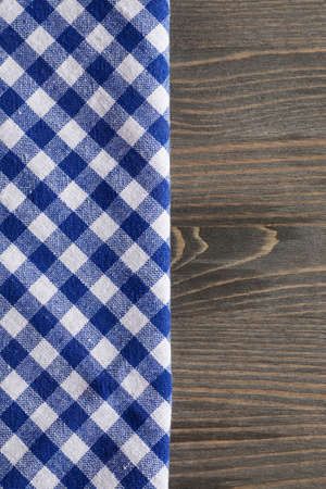 Blue checkered napkin on gray wooden table, mock up, text space, selective focus, verticalの写真素材
