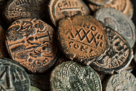 Pile of beautiful ancient copper coins, close-up shot, overhead viewの写真素材