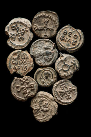Pile of antique post seals isolated on black, vertical overhead viewの写真素材