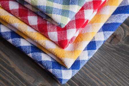 Checkered colored napkins on wooden table, close-up shotの写真素材