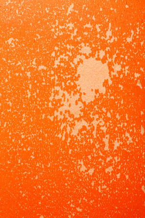 Bright orange shabby texture with peeling paint close-up shot, vertical.