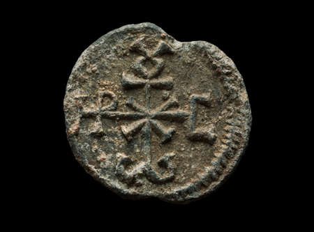 Ancient round post seal made of lead isolated on blackの写真素材
