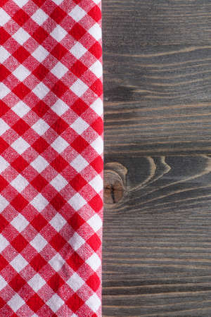 Red checkered napkin on gray wooden table, mock up, text space, selective focus, verticalの写真素材