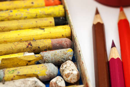 Macro shot of used crayons in box and pencilsの写真素材