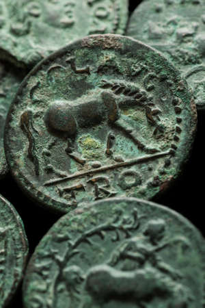 Ancient copper roman coins with horse image close-up shot, verticalの写真素材