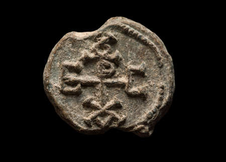 Ancient post seal with symbols on it, isolated on blackの写真素材