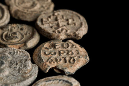 Ancient post seals made of lead on black background, text space, close-up shot selective focusの写真素材