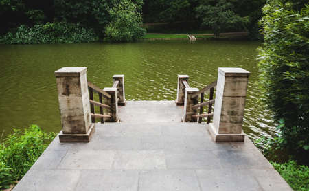 Stone pier among bushes on the lake, selective focusの写真素材