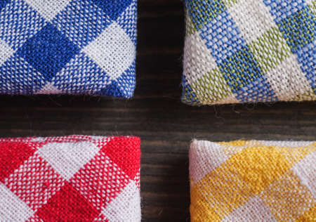 Corners of colored checkered napkins, close-up shot, overhead view
