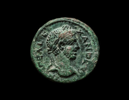Ancient copper roman coin of emperor Alexander, isolated on black, close-up shotの写真素材
