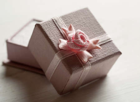Open pink gift box with bow on the top.の写真素材