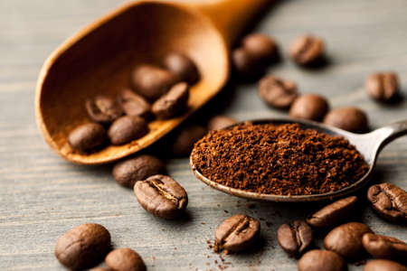 Coffee in a metal and wooden spoon closeup.の写真素材