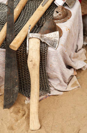 Old metal axe among other medieval weapon and equipment.の写真素材