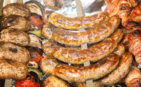 Fried sausages on metal skewer, selective focusの写真素材