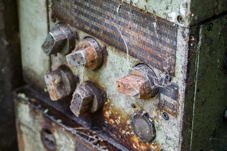 Old rusted control elements with dirt and spider webの写真素材