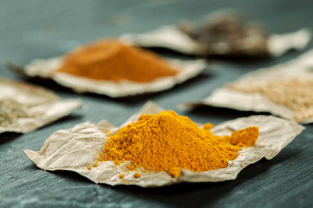 Heap of turmeric on a piece of paper macro shot