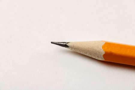 Sharpened pencil on a white blank sheet of paper, macro shotの写真素材
