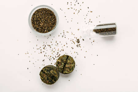 Dry green tea, compressed tea on a white background, top viewの写真素材