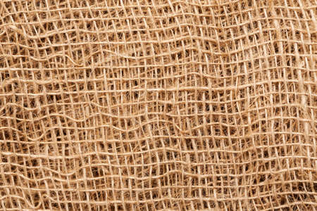 Burlap sack abstract texture with threads, macro shot