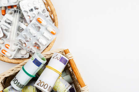 Different medications and pills with euro banknotes on a white background