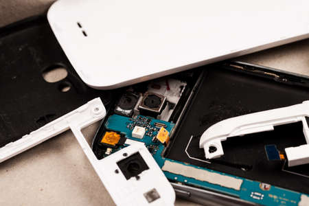 Disassembled cell phones and other gadgets in repair shopの写真素材