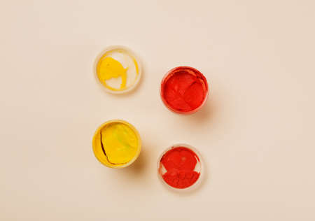 Open small paint jars on a table, selective focus, top viewの写真素材