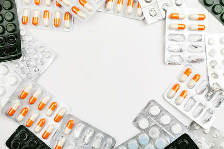 Medications and pills on a white background closeup shot with text space in the centerの写真素材