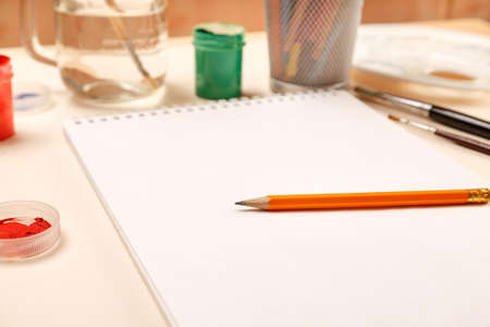Blank sheet of paper with pencil on it and other stuff for drawing, selective focusの写真素材