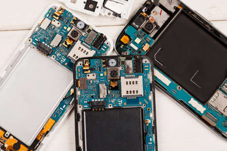 Disassembled cell phones and other gadgets in repair shop