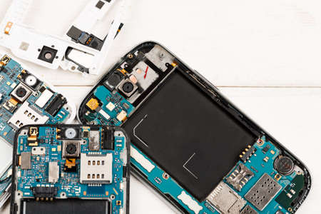 Disassembled cell phones and other gadgets in repair shop