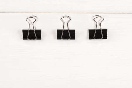 Three metal paper clips on a white background