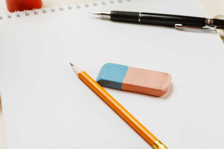 Pencil and eraser on a blank sheet of paper, selective focusの写真素材