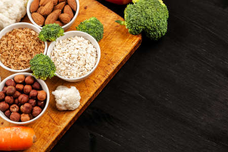 Fresh raw vegetables with nuts and cereals for cooking or eating. Vegetarian food. Top view