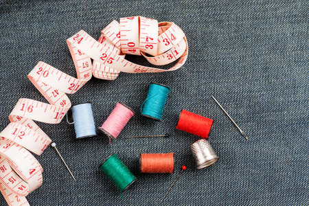 Set of tools and accessories for sewing and needlework with threads in spools, needles, measuring...