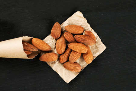 Almond on a piece of paper with paper bag macro shot, top viewの写真素材