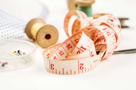 Set of tools and accessories for sewing and needlework with threads in spools, needles, measuring...