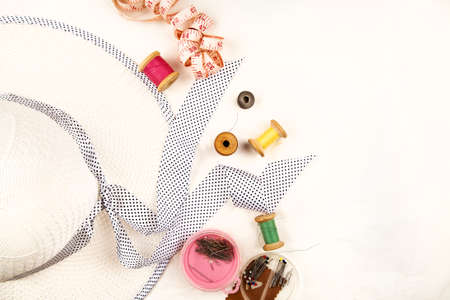 Set of tools and accessories for sewing and needlework with threads in spools, needles, measuring...
