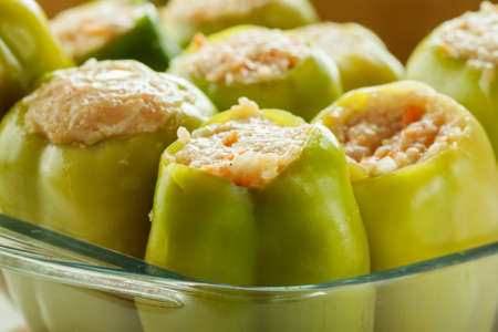 Fresh green bell peppers stuffed with meat with rice in a glass dishの写真素材