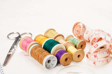 Set of tools and accessories for sewing and needlework with threads in spools, needles, measuring...