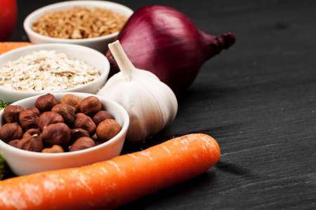 Fresh raw vegetables with nuts and cereals for cooking or eating. Vegetarian food.の写真素材